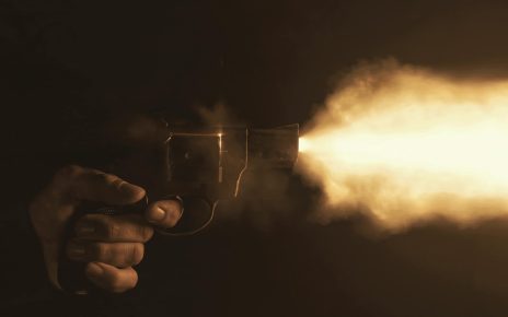 person firing a gun